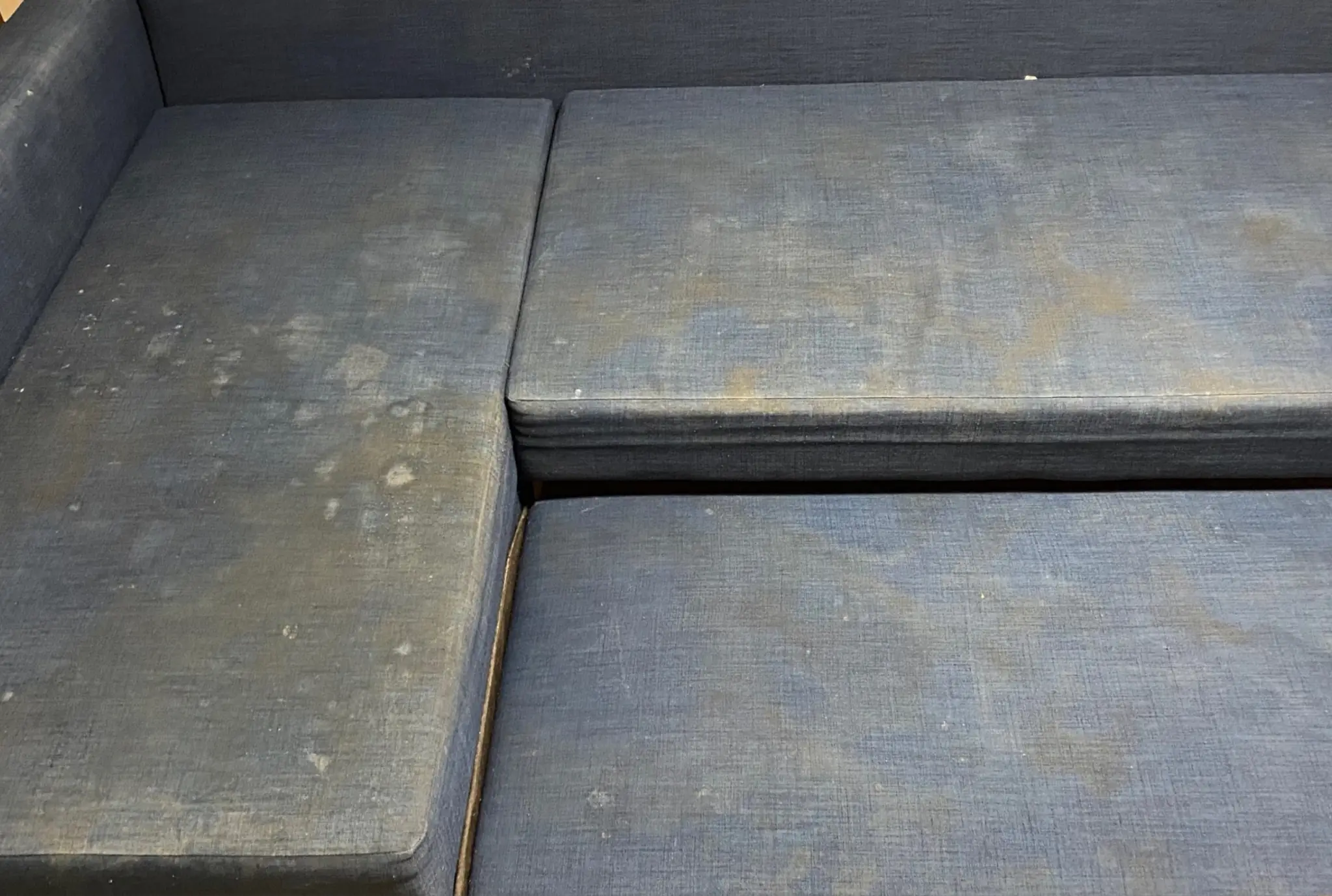 Stark verschmutzte blaue Couch vor der Reinigung in Bonn